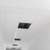 Low angle view on PVC tiles. Installing ceiling lighting