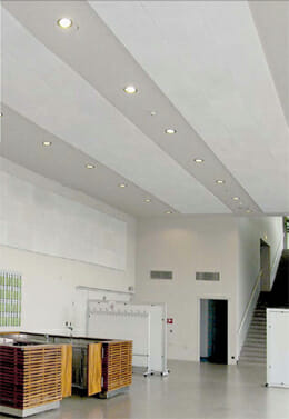 QuietStone™ Recycled Glass Ceiling And Wall Solutions being used in a large, white space.